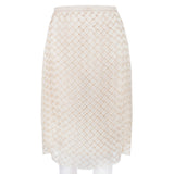 A Christopher Kane pencil skirt which is intricately shaped to appear woven