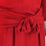 An elegant midi dress in pillar box red by Giambattista Valli