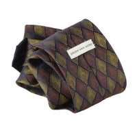 Dries Van Noten Art Deco Patterned Tie  Colour: Copper, bronze and midnight blue Made in Italy Material: 100% silk Blade width: 7.5 cm  Dries Van Noten tie in an Art Deco inspired jacquard silk Monochrome Art Deco pattern to back in ink blue with contrasting stripe