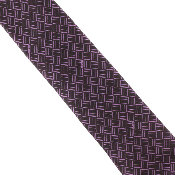 Dunhill silk tie featuring an abstract longtail print inspired by the exaggerated typography of the iconic dunhill logo.