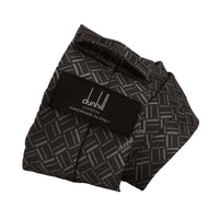 Dunhill silk tie featuring an abstract longtail print inspired by the exaggerated typography of the iconic dunhill logo.