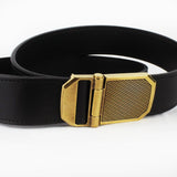 Dunhill black leather belt An antique brass tone buckle in an engraved engine turn pattern