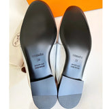 Hermes Trocadero mules in a metallic silver grained leather