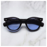 Cutler & Gross 1390 round sunglasses in black on blue