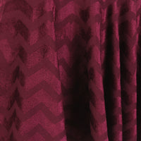 Alaia circular skater skirt in claret velvet with chevron patterning