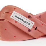 Alexander McQueen narrow silk tie in coral claret and red in a skull and star pattern