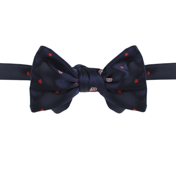 Alexander McQueen silk bow tie in midnight blue with a red and pink skull and star pattern
