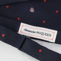 Alexander McQueen silk bow tie in midnight blue with a red and pink skull and star pattern