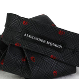 Alexander McQueen silk tie in a charcoal grey and red prince of Wales check and skull pattern